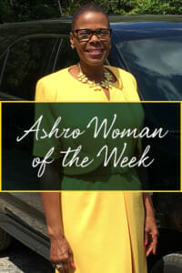Ashro Woman of the Week, Carolyn, an African-American woman with short hair, wearing a yellow jacket dress.