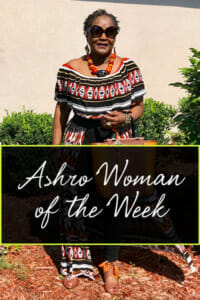 Ashro Woman of the Week, Dianne, a black woman wearing an off-the-shoulder print dress and red necklace.
