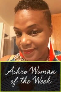 Ashro Woman of the Week MICHELLE, a black woman with short hair, wearing a red necklace and drop earrings.