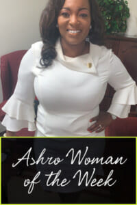 Ashro Woman of the Week ANGELA, a smiling African-American woman wearing a white dress.