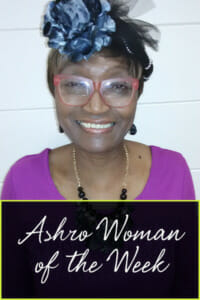 Ashro Woman of the Week Ruth, a smiling African-American woman wearing a purple dress.