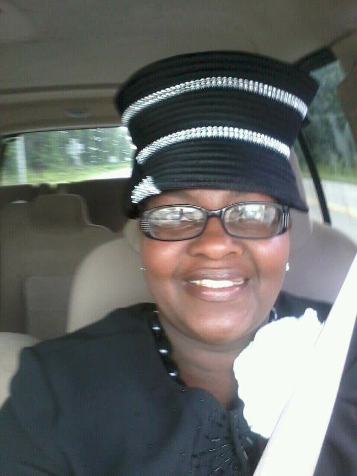 Ashro Woman of the Week Brenda, a smiling African-American woman wearing a black dress and black and white hat