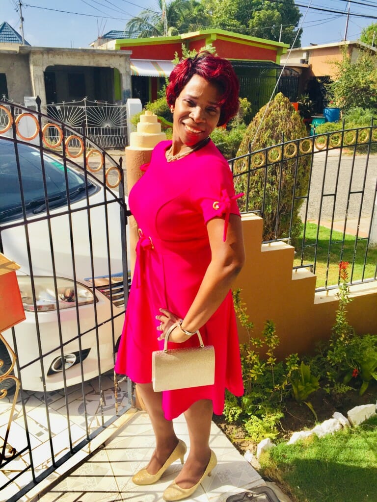 black woman wearing red dress leaving for church
