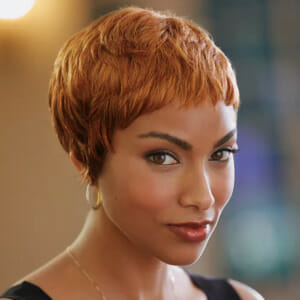 Black woman wearing copper colored wig.