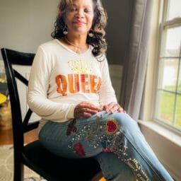 Kimberly (Ashro customer) seated wearing Ashro Royal jeans with Ashro Queen shirt.