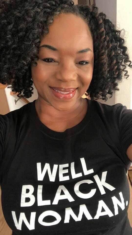 Black woman in Well Black Woman t-shirt