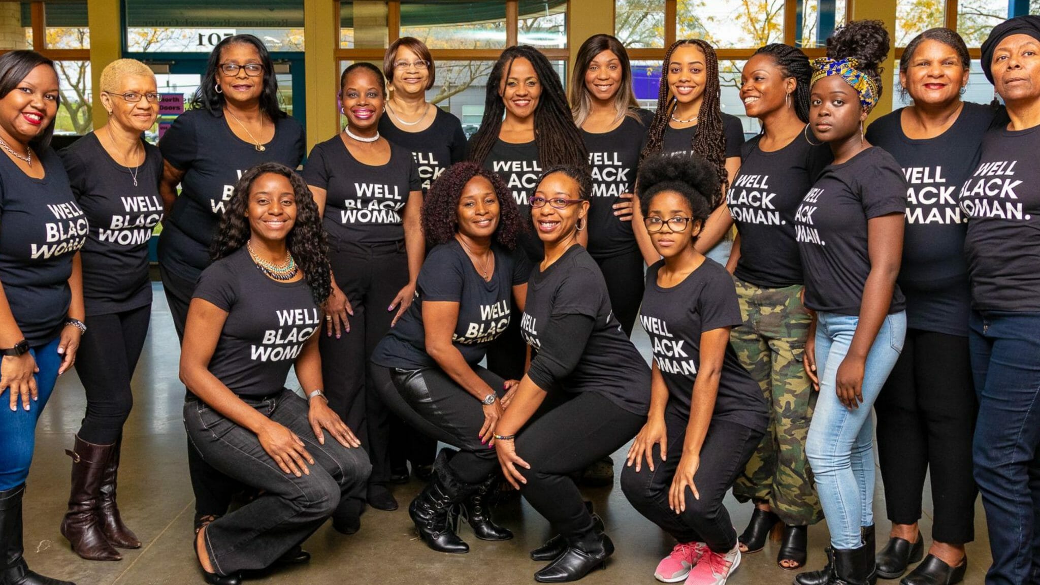 group of Black women wearing Well Black Woman t-shirts