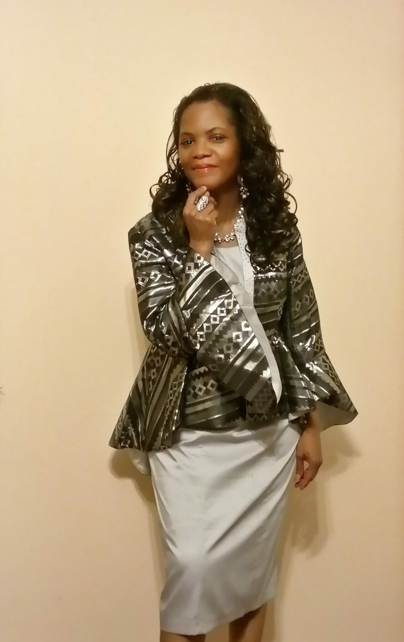 Kimberly (Ashro customer) posing forward in black and silver metallic jacket dress.