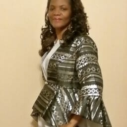 Kimberly (Ashro customer) posing side-front in black and silver metallic jacket dress.