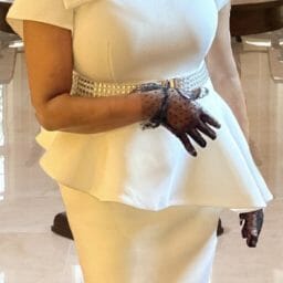 Black woman wearing white church dress