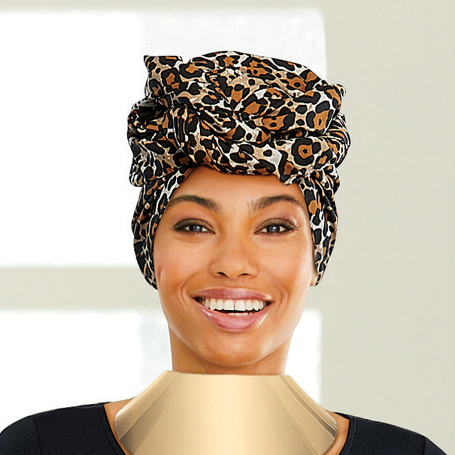 African American woman wearing Animal Print Headwrap in Leopard, gold Temptress Choker and a black top.