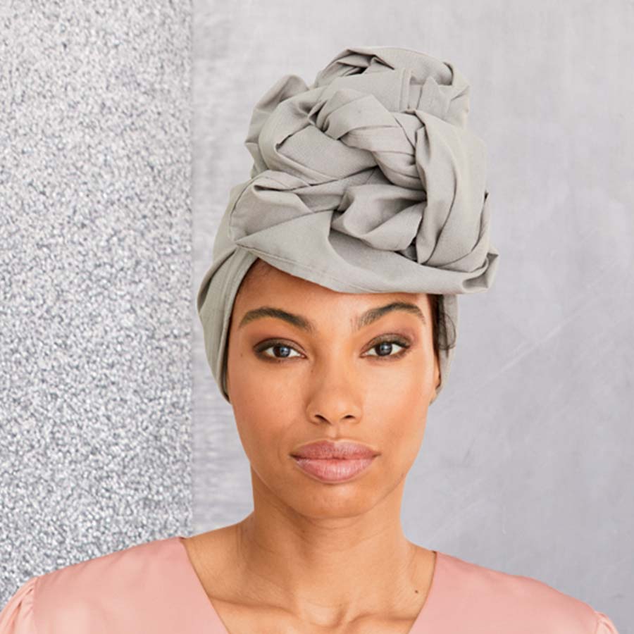 African American woman wearing a white headwrap.