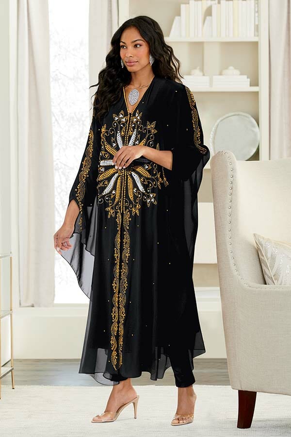 African American woman wearing sheer black caftan with gold and silver beaded design. 