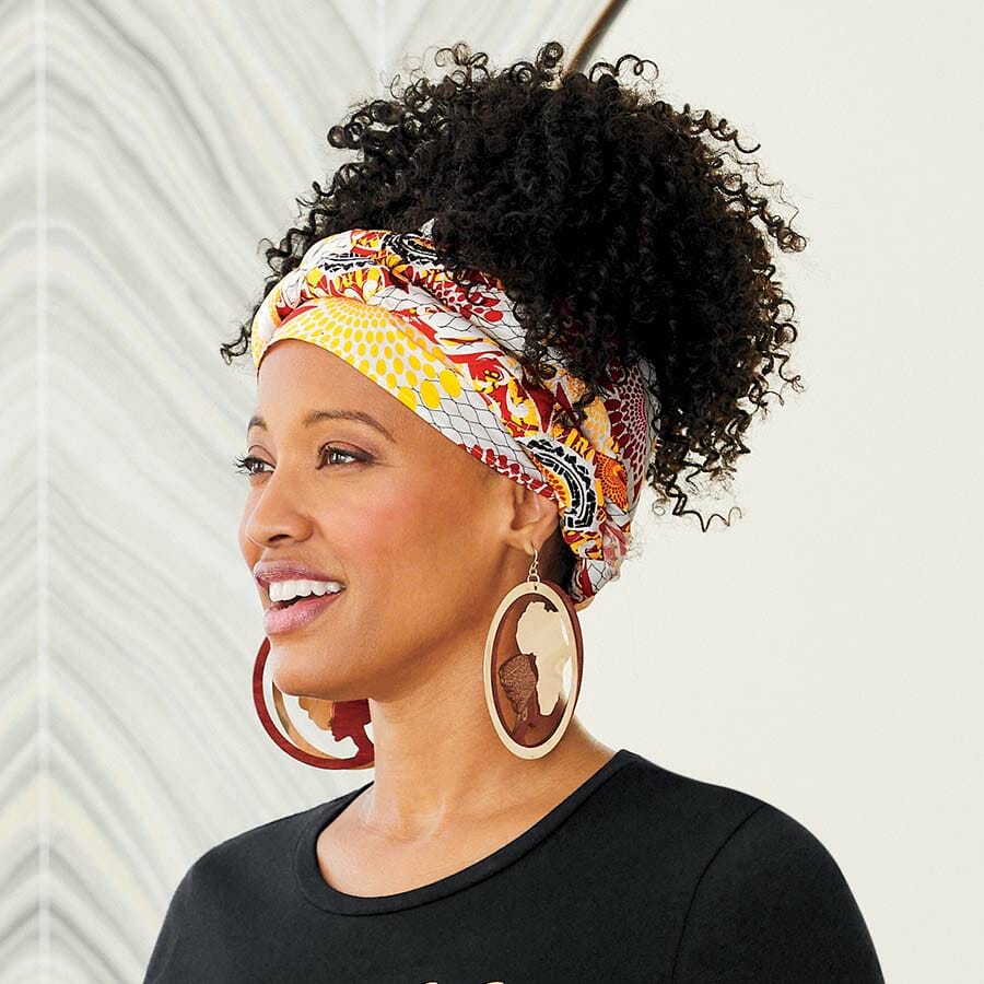 African American woman wearing black, red, orange, yellow and white print headwrap