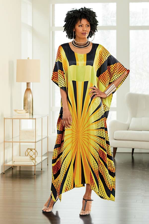 African American woman in yellow, orange and black caftan.