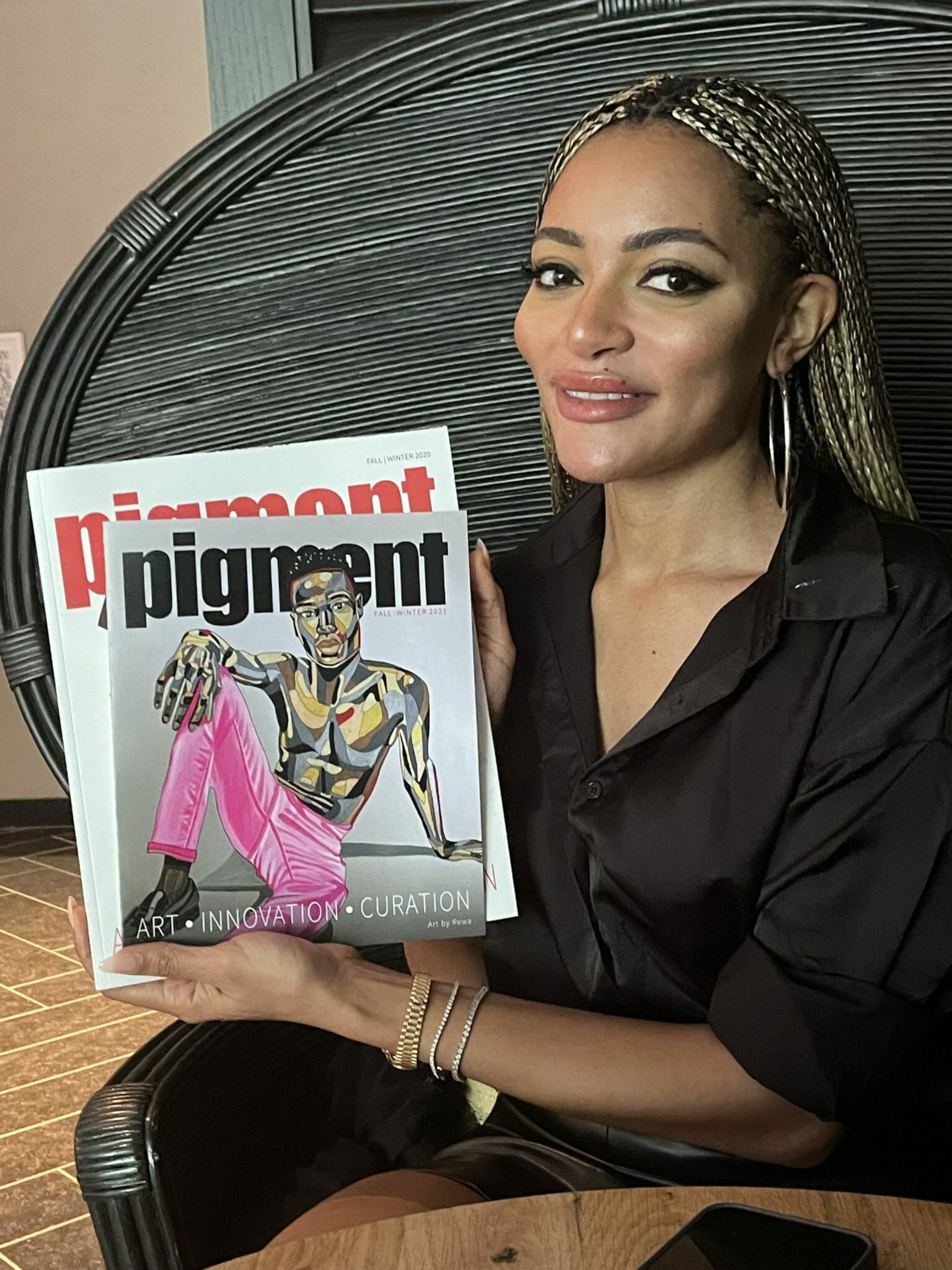 Photo of a Black Woman holding Pigment Int. Magazine.