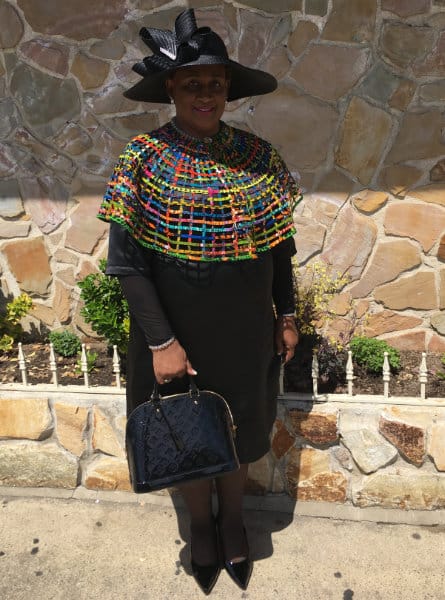 woman in a black dress and a multicolored shawl