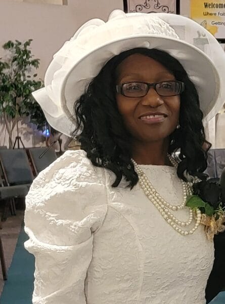 woman in a white dress with a white hat