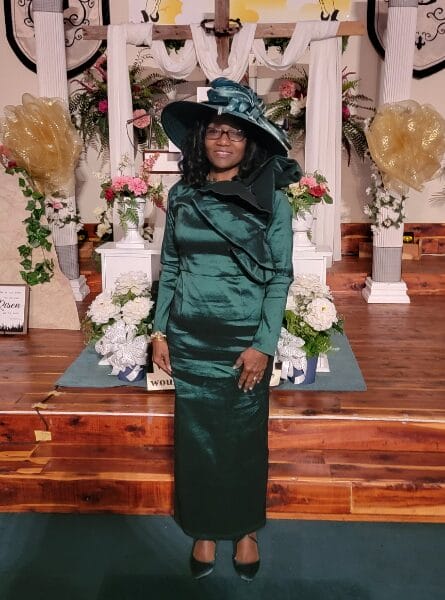 woman in a green dress and hat